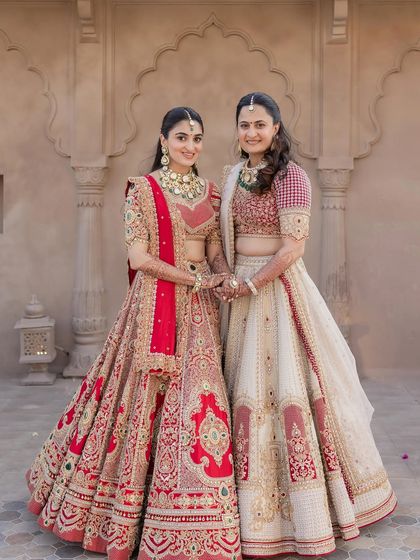 A lovely portrait of the bride with her sister. Both are wearing complementary outfits, and their makeup is done to suit their individual styles.