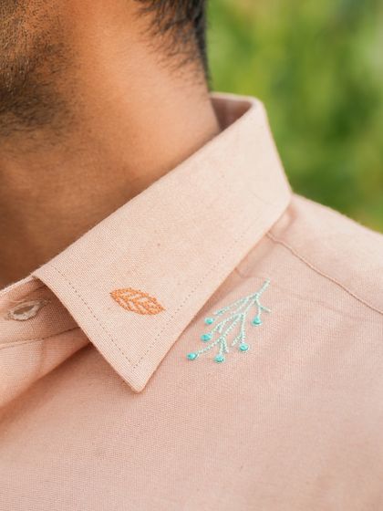 A detail of the collar on our peachy llama shirt, showing the small, thoughtful embroidery that makes each piece special.