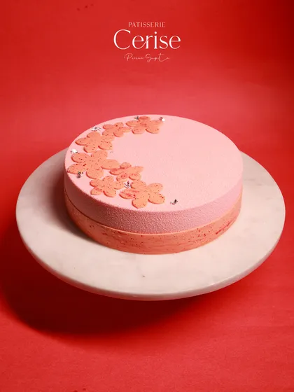 Another view of the Strawberry Fields entremet, with its delicate floral decorations and beautiful two-tone color.