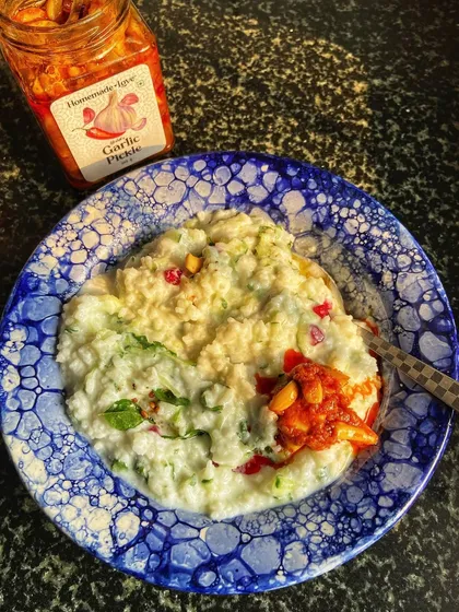 A beautiful bowl of curd rice with a generous helping of our Garlic Pickle. The tangy, spicy garlic cloves add a wonderful texture and flavour burst to this simple and soothing dish.