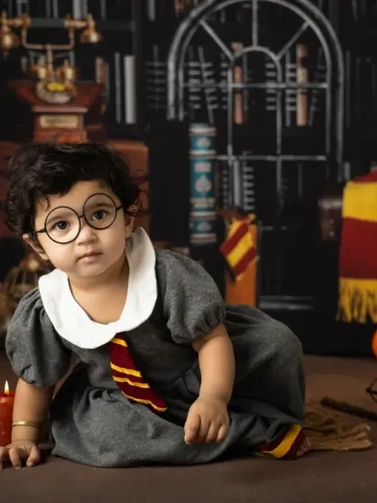 It's not just for Harry. This little girl makes a perfect Hermione Granger, captured in our Hogwarts library set for her first birthday.