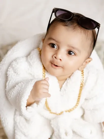 A close-up shot of the boss baby, with his sunglasses pushed up, looking cool and confident.