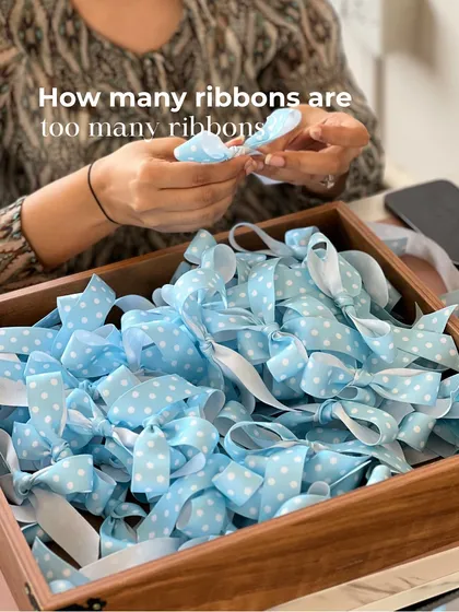 How many ribbons are too many ribbons? The answer is, you can never have enough! Prepping a mountain of blue polka-dot bows for the baby boy announcement hampers.