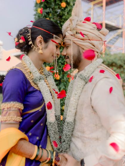 A romantic moment under a shower of petals, capturing the love and tradition of the day.