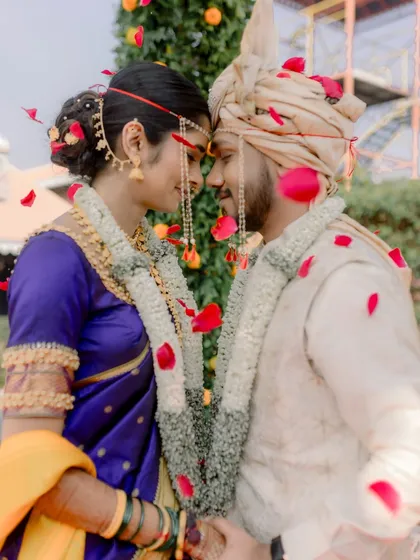 A romantic moment under a shower of petals, capturing the love and tradition of the day.
