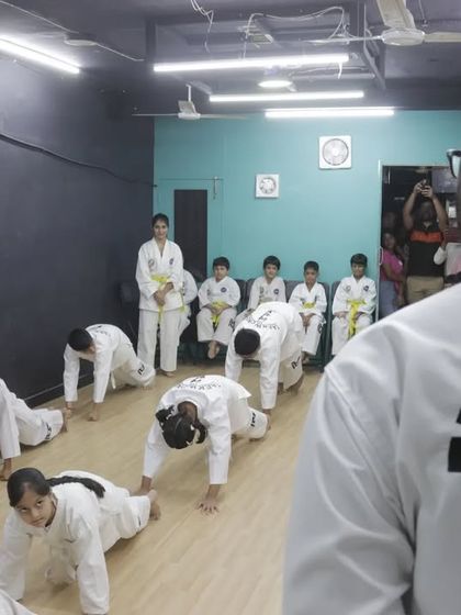 Students perform conditioning exercises like push-ups as part of their grading, proving their physical readiness for the next level.
