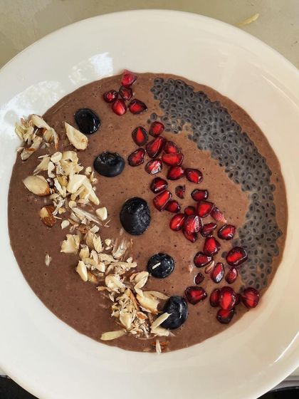 This delicious chocolate avocado mousse is a double whammy: scrumptious and healthy. It's a rich, creamy bowl of avocado, cocoa powder, and whey protein, topped with berries, nuts, and chia seeds.