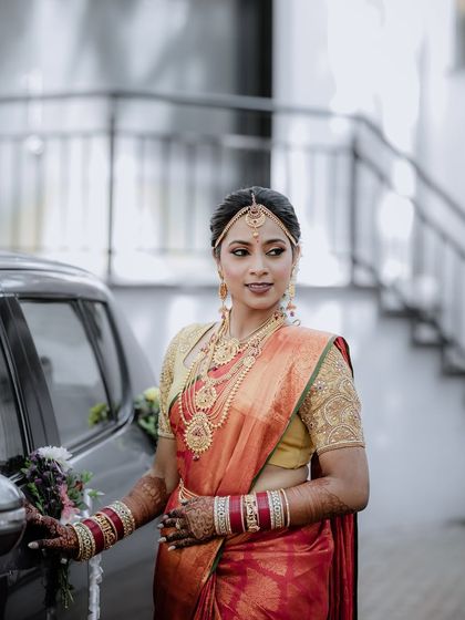 A classic portrait of the bride by a car. Her confident pose and the beautiful lighting make for a very glamorous shot.