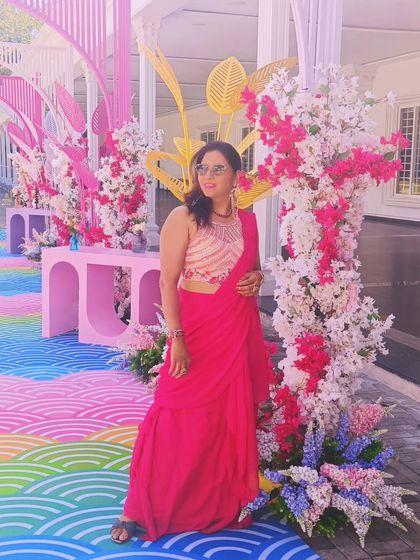 Enjoying the beautiful, colorful decor at a Haldi event. The vibrant setup perfectly complements the joyful celebration.