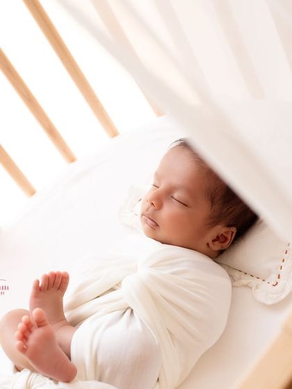 Peeking through the crib, this shot feels so intimate and real. I use the elements of your home to frame beautiful, story-rich images of your little one.