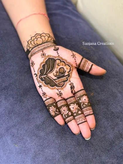 A closer look at the Karwachauth sieve design, with delicate details like hanging diyas and stars.