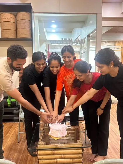We believe in celebrating together. The WellFlow team and members join hands, symbolizing the unity and supportive energy of our studio.