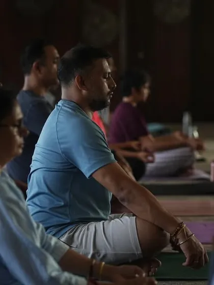 A close-up of students in seated meditation. This image reflects the grounding and transformative power of the practice, a journey that unfolds both within and beyond the mat.