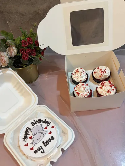This gift set is perfect for a birthday celebration for your love. It includes a custom bento cake with a cute illustration and a box of six red velvet cupcakes with cream cheese frosting.