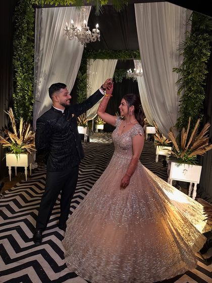 The couple sharing a dance. The bride's fairytale gown and sparkling makeup make her look like a princess.