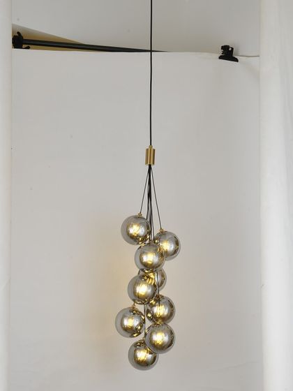 A cluster of smoked glass pendants, perfect for creating a focal point in a room with a high ceiling.