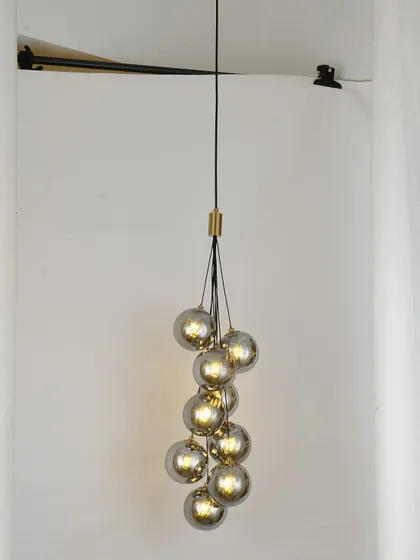 A cluster of smoked glass pendants, perfect for creating a focal point in a room with a high ceiling.