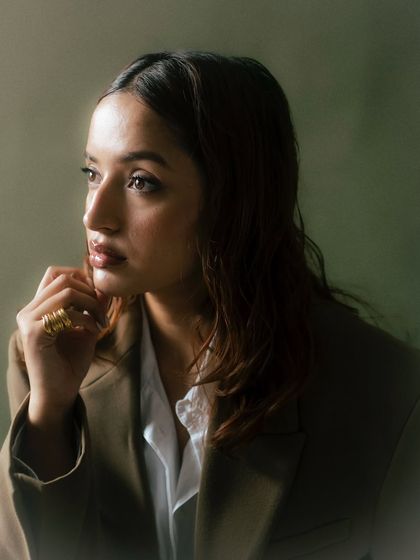 A profile shot with beautiful, soft side-lighting. This image highlights the model's features and the texture of her hair, creating a classic and elegant portrait.