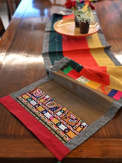 An autumnal patchwork runner trimmed with vintage tribal embroidery from Kutch. The piece combines hand-spun Kala cotton with other scrap fabrics.