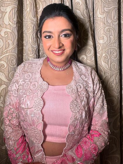 The client looking pretty in pink, her sparkling ponytail completing the look.