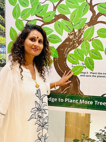 A participant in beautiful traditional attire adds her pledge, showing that the love for nature is a universal value that connects us all.