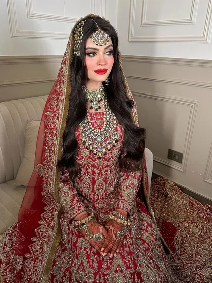 A side profile showcasing the beautiful maang tikka and the cascading layers of the bridal necklace. This look is all about royal elegance for your special day.