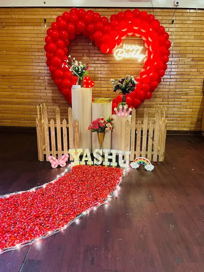 For a truly grand romantic gesture, I can create a stunning focal point like this large heart-shaped balloon arch. Paired with a glowing neon sign and a dreamy pathway of red petals, this setup is designed to make your proposal or special birthday celebration absolutely unforgettable.