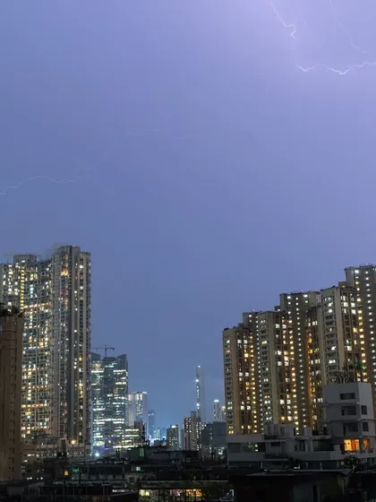 Thin tendrils of lightning spread across the sky during a Mumbai thunderstorm.
