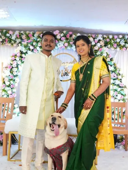 We love it when all family members, including furry ones, are part of the celebration. The couple poses with their dog at their engagement ceremony.