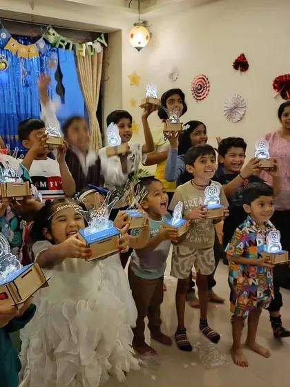 Look at these proud inventors! In our workshops, every child gets to build and take home their own creation, like these amazing custom light-up lamps. It's a glowing reminder of what they can achieve.