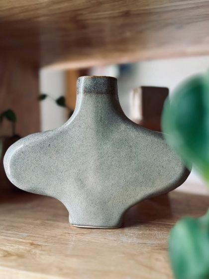 A wide, sculptural vase with a beautiful gray-green glaze. Hand-building allows for shapes and forms that are difficult to achieve on the wheel.