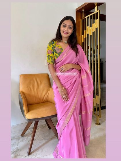 A full-length view of the client's outfit, showing how the modern floral blouse pairs beautifully with the traditional pink saree.