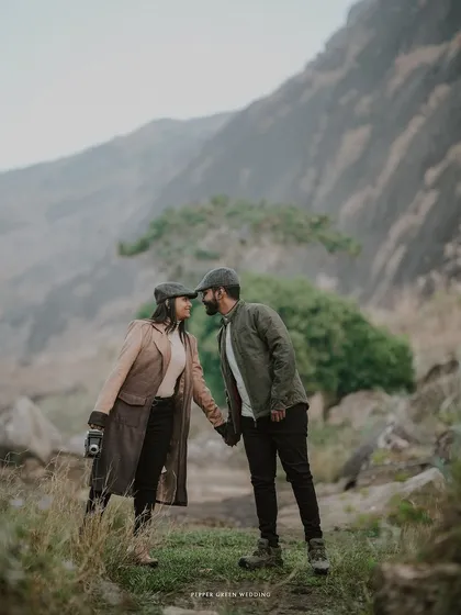 A romantic portrait against the misty hills, their classic outfits and the natural setting combining for a truly timeless pre-wedding photograph.