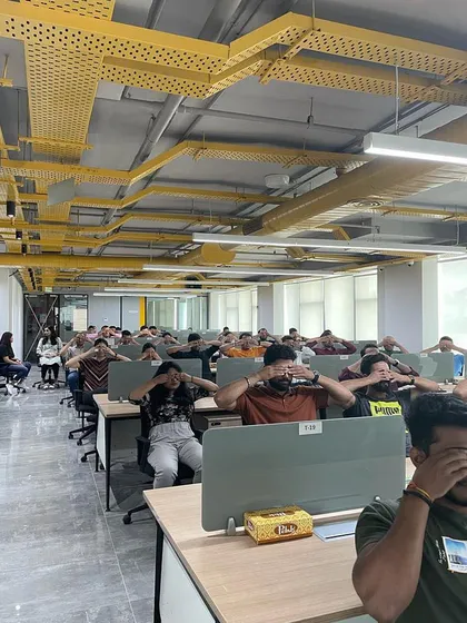 Yoga doesn't always require a mat. This is a chair yoga session in a typical office setting, where we are practicing techniques to release tension directly at the workstation. These sessions are designed for convenience and maximum impact on employee well-being.