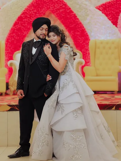 A tender moment between the couple. The bride resting her hand on her groom shows their comfort and affection for each other.