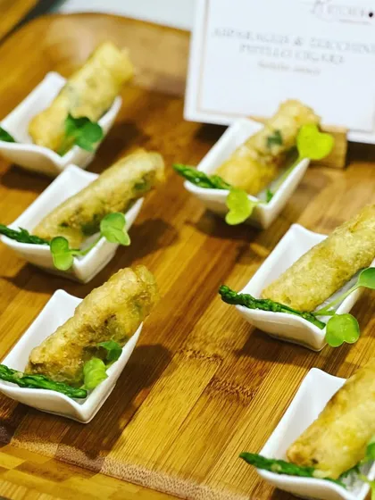 Crispy asparagus and zucchini cigar rolls served as an elegant passed appetizer during a sit-down event.