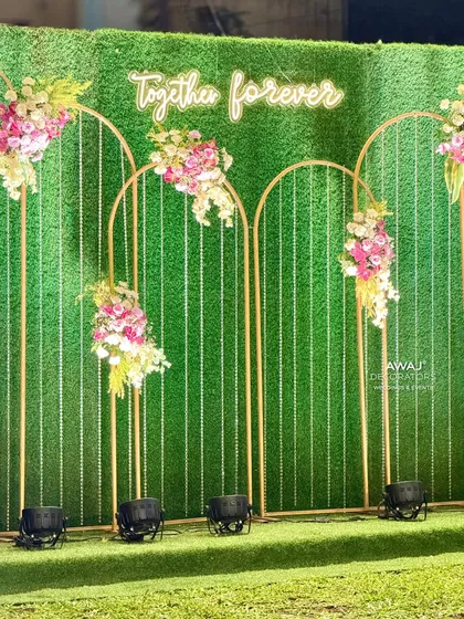 A "Together Forever" neon sign against a green hedge wall, a modern and romantic backdrop for a photo op.