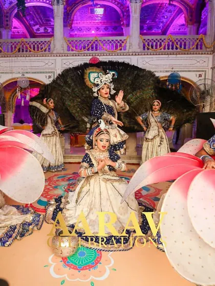 A stunning Raasleela performance at Chomu Palace. An artist dressed as Krishna is framed by a backdrop of real peacock feathers, with dancers creating a beautiful formation around him.