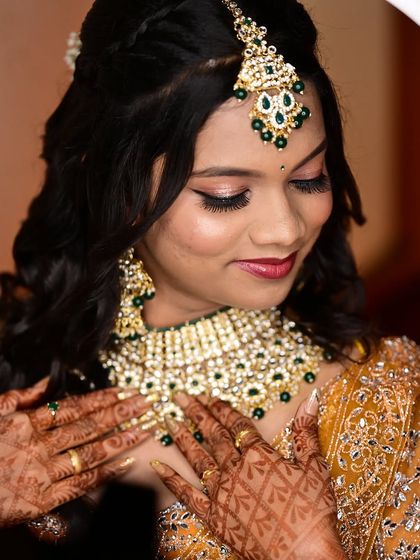 A close up of the bride's reception makeup, framed by a ring light. The focus is on the shimmery eye makeup and flawless skin.