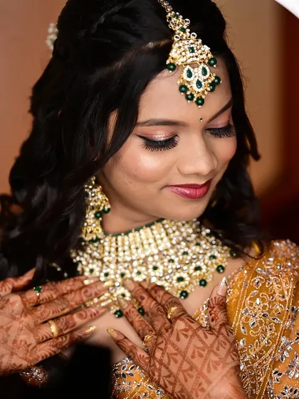 A close up of the bride's reception makeup, framed by a ring light. The focus is on the shimmery eye makeup and flawless skin.
