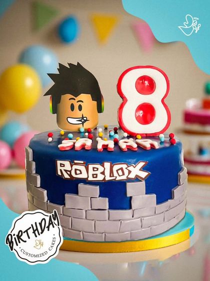 Another awesome Roblox cake, this time for an 8th birthday. The design features a character head, the game logo, and a brick wall base.