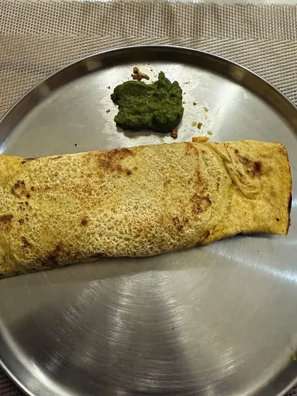 A besan cheela (gram flour pancake) served with green chutney. This is a high-protein, gluten-free option that is great for weight loss.