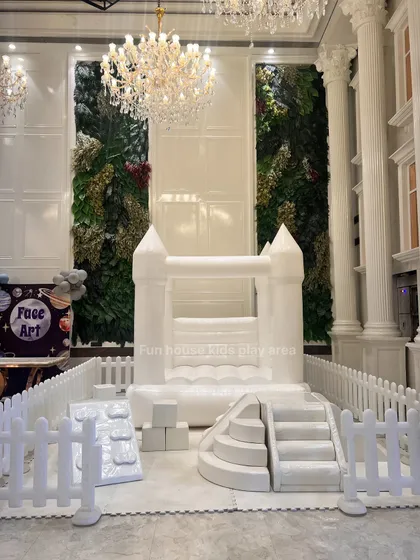 Our elegant white play area set up indoors under beautiful chandeliers, showing how our equipment can complement even the most luxurious decor.