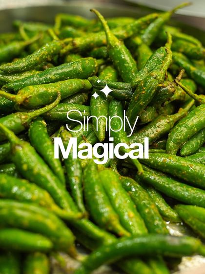 A pile of fresh green chillies, lightly coated in spices. This is the simple magic behind our flavourful chilli pickles.