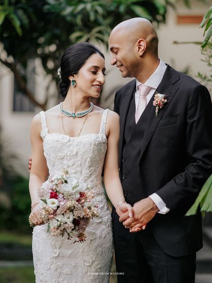 A beautiful portrait of Priya and Matthew after their wedding. Her elegant gown and his classic suit, combined with their loving gaze, create a picture of timeless grace.