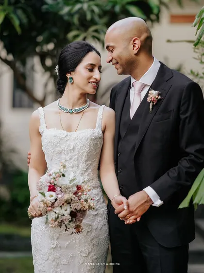 A tender moment between the bride and groom. The intricate lace of her gown and the soft light create a feeling of timeless elegance in this Christian wedding portrait.