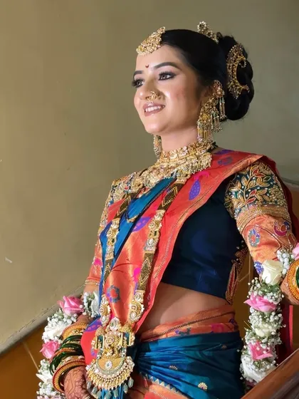 A candid shot of the bride on a staircase, adorned with floral garlands.