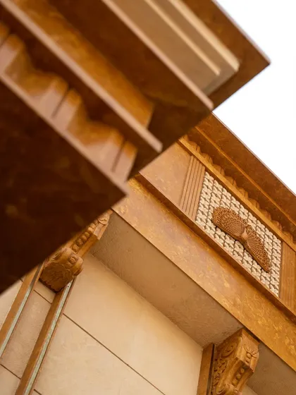 A close-up of the hand-chiseled and CNC-cut motifs on the blended Jaisalmer yellow sandstone facade. Every profile, edge, and motif is shaped to hold its form and color over time.