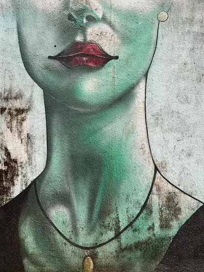 A close-up of a hauntingly beautiful mural of a woman's face. My street art photography focuses on the details and emotions conveyed by the artists.