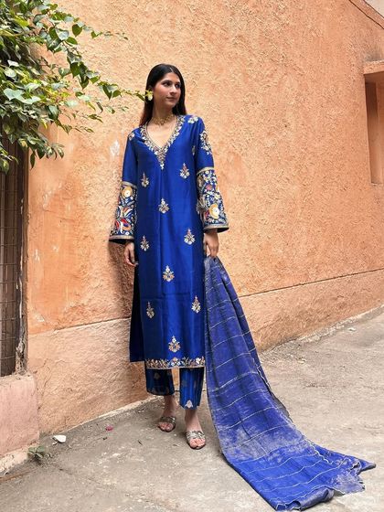 A beautiful royal blue kurta set with intricate Kashmiri-inspired embroidery. This is a perfect example of a timeless, elegant outfit for a winter wedding or festive event.